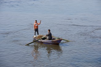 Boys in a rowboat fishing on the Nile, Luxor, Egypt