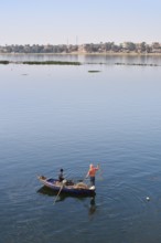 Boys in a rowboat fishing on the Nile, Luxor, Egypt