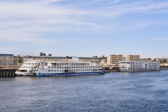 Nile cruise ships at a pier on the banks of the Nile, Egypt
