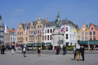 Market square Grote Markt with Jan Breydel and Pieter de Coninck monument and guild houses, Bruges,