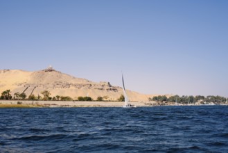 Qubbet el-Hawa with the rock tombs on the Nile, Aswan, Egypt