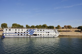 Nile cruise ship Radamis II at pier and double temple of Kom Ombo, Kom Ombo, Egypt