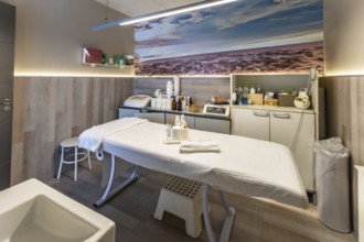 Beauty salon treatment room offering services for skin care, massage, and wellness, featuring a
