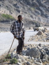 Bedouin standing on the side of the road, Oman