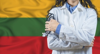 Healthcare professional with Lithuania flag background. Professional doctor holding stethoscope on