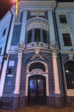 Entrance portal of a bank house illuminated at night, Czernowicz, Ukraine