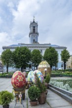 Traditionally painted and embroidered Easter eggs, Czernowicz, Ukraine in the back the town hall,
