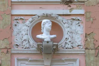 Male bust on a dilapidated 19th century house façade, Czernowicz, Ukraine