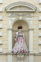 Mannequin wearing Ukrainian traditional costume in a niche of a house, Czernowicz, Ukraine
