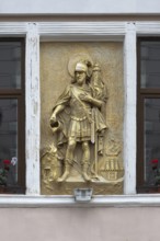 Gilded relief of St. Florian on a house wall, Czernowicz, Ukraine