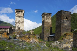 Stone towers in a historic village under clear blue sky in a hilly landscape, defensive towers,