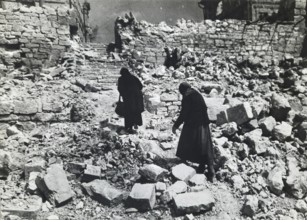 Two old woman in the rubble of a destroyed residential building, April 1945, Berlin