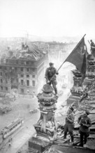 At the Berlin Reichstag, May 2, 1945, three Soviet soldiers fly the flag of the Soviet Union. The