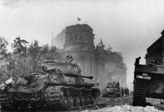 View of the Reichstag on May 1, 1945 with the Soviet flag on the roof. View from the Brandenburg