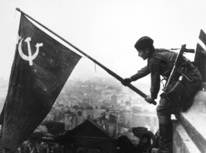 At the Berlin Reichstag, May 2, 1945, three Soviet soldiers fly the flag of the Soviet Union. The