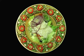 Mixed salad with sheep cheese on a colorful plate, Ukraine