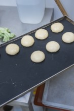 Seven dough pieces prepared on a baking tray in a kitchen, baking rolls, Haselstaller Hof,