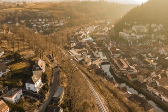 Small river town with train tracks and autumn tree scenery, test trip on the new Hermann-Hesse