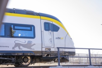 Modern yellow and white train on tracks in sunny surroundings, test run on the new Hermann-Hesse