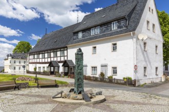 Market fountain with historical column on Bärenstein market square, Altenberg, Saxony, Germany