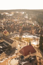 Historic city view with church and snow-covered roofs under bright blue sky, Freudenstadt, Black