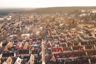 Panoramic view of a city in sunlight with numerous roofs and adjacent forest, Freudenstadt, Black