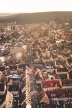 Aerial view of a city with red roofs surrounded by forests and light snow, Freudenstadt, Black
