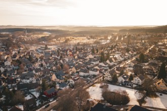 Aerial view of residential area at sunset, snow-covered landscape and rooftops, Freudenstadt, Black