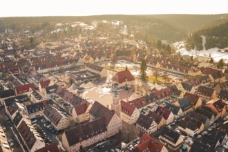 Comprehensive aerial view of an old town with central market square and church in a natural