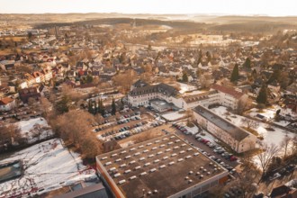 Aerial view of an urban landscape in winter with a variety of buildings and cars, Freudenstadt,