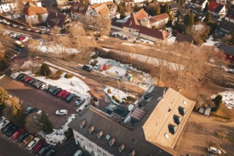 Bird's eye view of a snowy road with buildings and parked cars on a wintry day, Freudenstadt, Black