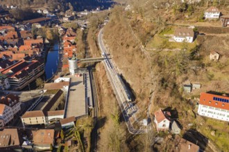 City panorama with train lines along a hill that run through an urban environment, test run on the