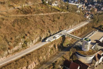 Aerial view of a railway station in an urban area, surrounded by nature and architecture, test run