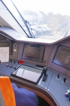 Train driver's cab with modern control monitors and control elements, test run on the new