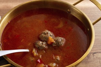 Romanian soup with meatballs, vegetable soup with meatballs, in a pot, homemade, no people