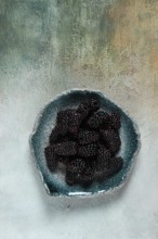 Fresh blackberry berry, on a plate, top view, no people