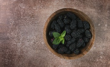 Blackberries, in a wooden bowl, top view, no people