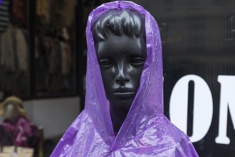 Window mannequin with rain cape in rain, Krakow, Poland