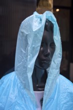 Window mannequin with rain cape in rain, Krakow, Poland