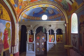 Interior view of an Orthodox chapel with colorful frescoes and icons, Nikorzminda Cathedral,