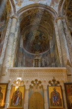Richly decorated Orthodox church wall with frescoes and icons in the interior, Nikorzminda