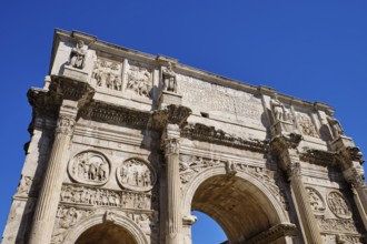 Arch of Constantine with ornate reliefs under blue sky, Rome, Lazio, Italy
