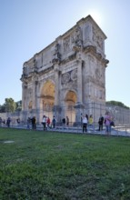 Arch of Constantine with detailed reliefs surrounded by tourists, Rome, Lazio, Italy