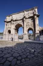 Arch of Constantine with detailed reliefs under blue sky, Rome, Lazio, Italy