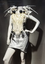 Spider-dress, eccentric, spider-like ecoskeleton as a white dress with AI and defense technology