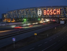 Traffic on the A8 motorway, blue hour, illuminated parking garage, Landesmesse Stuttgart, red-lit