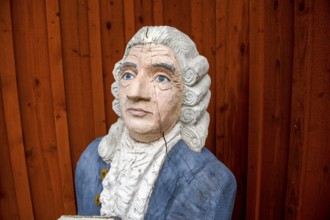 Wooden statue of botanist and founder of the binary nomenclature Carl von Linné with white hair and