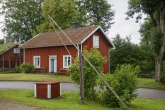 Red wooden house with green garden and trees, Linnés Råshult, Älmhult, Kronobergs län, Småland,