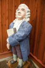 Wooden statue of botanist and founder of the binary nomenclature Carl von Linné with white hair and