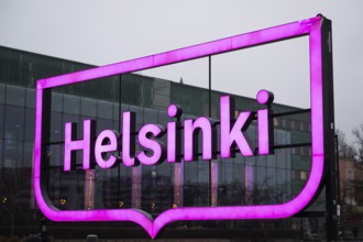Large pink city logo of Helsinki near Oodi Central Library and Cultural Center, Helsinki, Finland